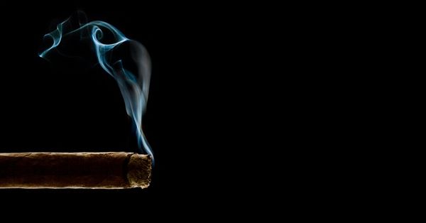 Lit cigar with blue smoke
